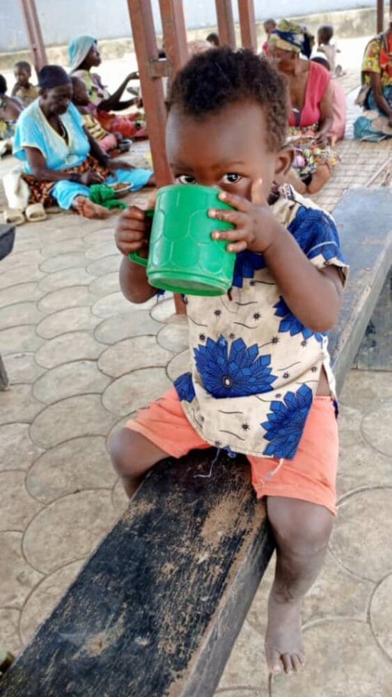 child drinking from a cup